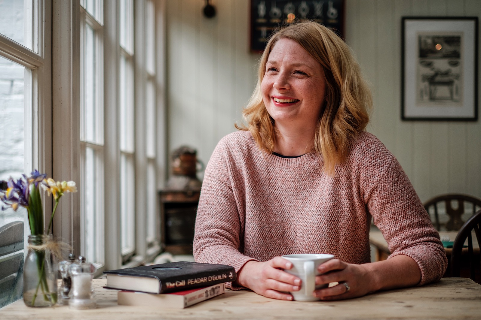 woman smiling and holding mug of coffee during creative corporate headshot session