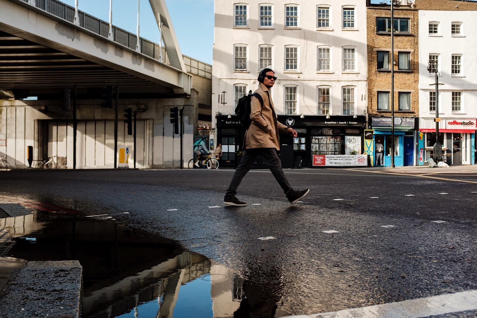 Man walking through Lodon streets wearing headphones