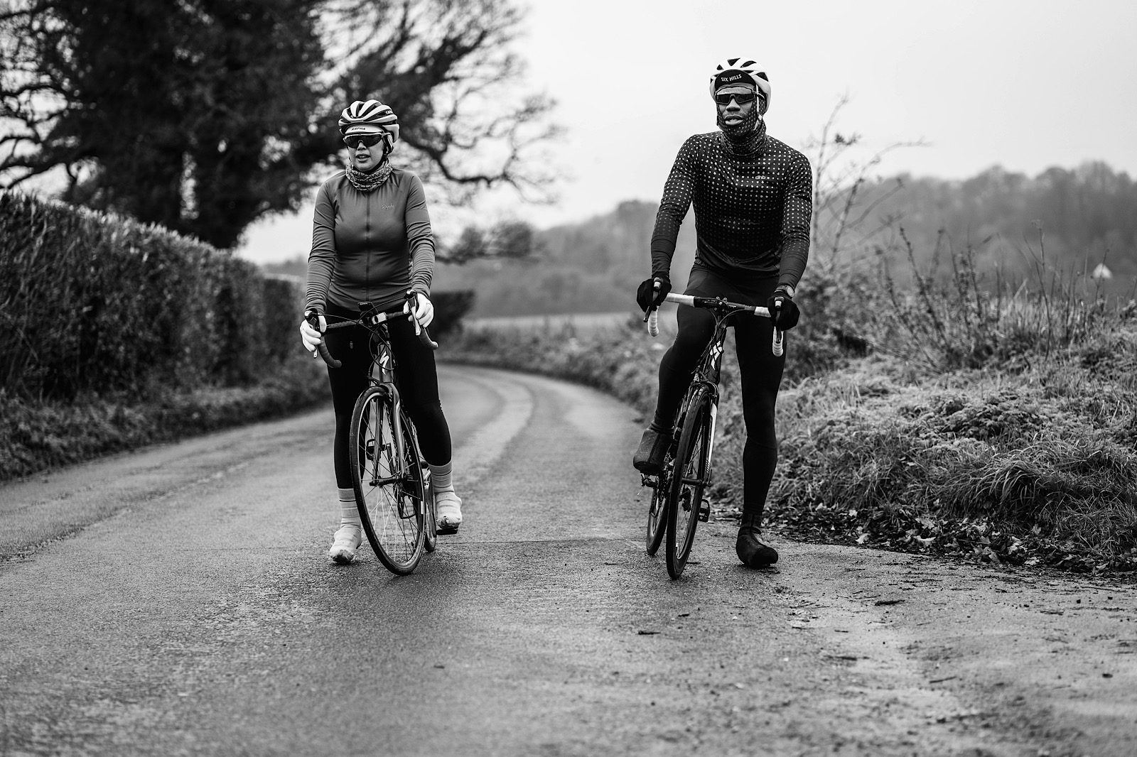Man & women on bikes on quiet country road