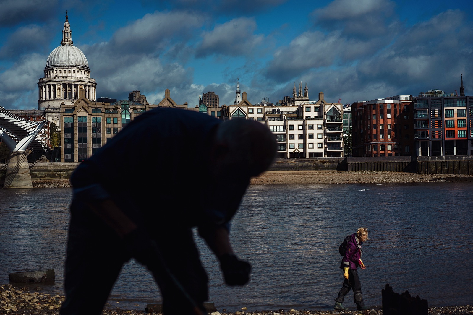 Mudlarkers searching the banks of the River Thames with St Pauls in background