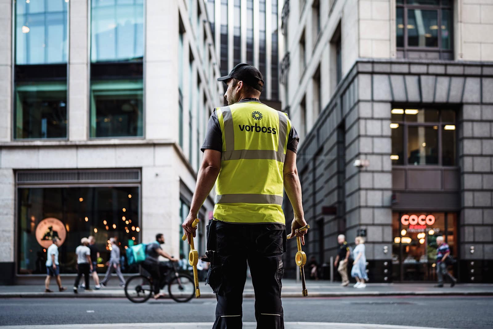 Vorboss employee holding equipment on busy London road